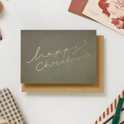 Katie Leamon | Tarjeta Navidad Warm Green Happy Xmas